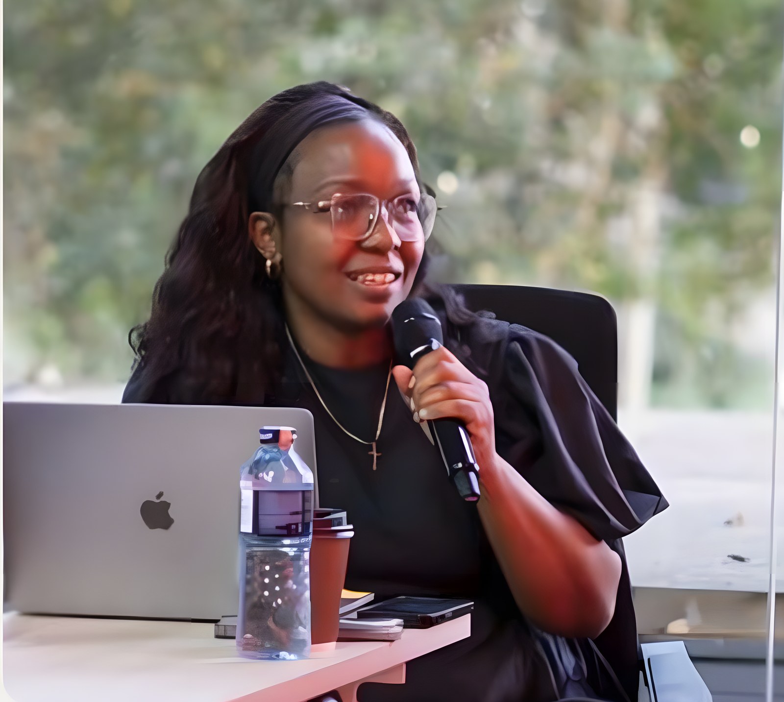 Agnes Muthoni speaking into a microphone